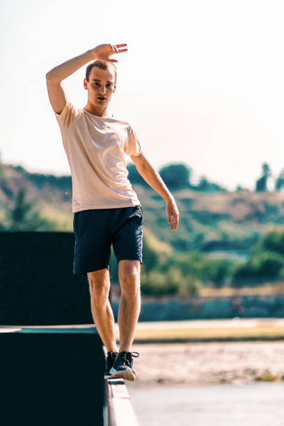 istock Young man training and balancing walking on the edge 1371286817
