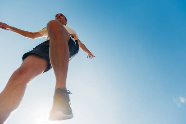 istock Carefree man below blue sky doing parkour training 1371287034