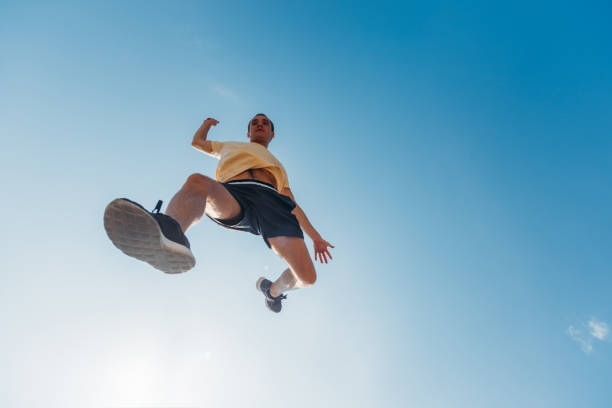 istock Cheerful parkour man below blue sky doing parkour 1371287041