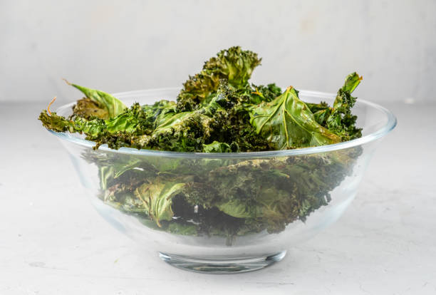 istock Healthy baked kale leaf chips in a glass bowl. 1371287658