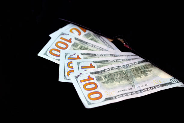 istock American money banknote inside a black wallet isolated on a black background, The reverse side of 100 $ One hundred American dollars bill 1371288839