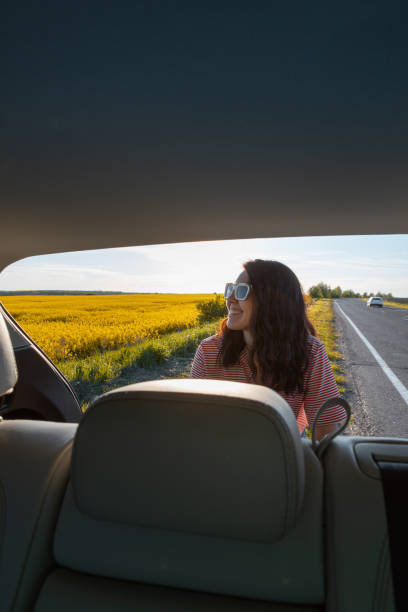 istock view from car trunk smiling woman at road side 1371291740