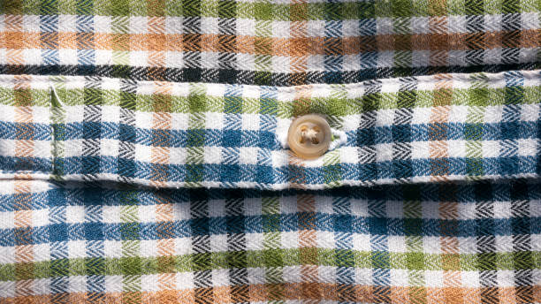 istock Button in orange, green, blue and white checkered shirt cuff 1371293434
