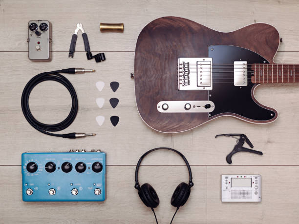 Flat lay with electric guitar and accessories on the light wooden floor