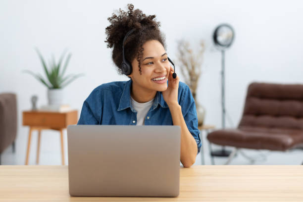 Portrait of happy African American female employee customer support services in headset, online consultation. Woman call center. Female customer support or sales agen stock photo