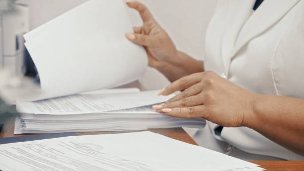 istock Businesswoman in white formal suit working with documents in the office. 1371294689