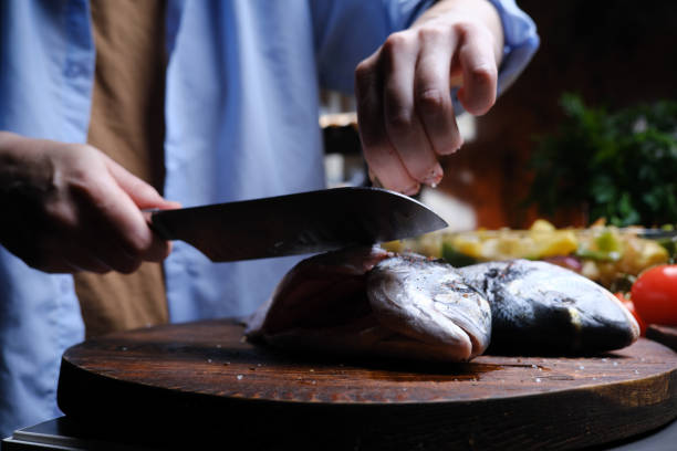 istock Preparing fresh gilthead bream for roasting with vegetables 1371298035