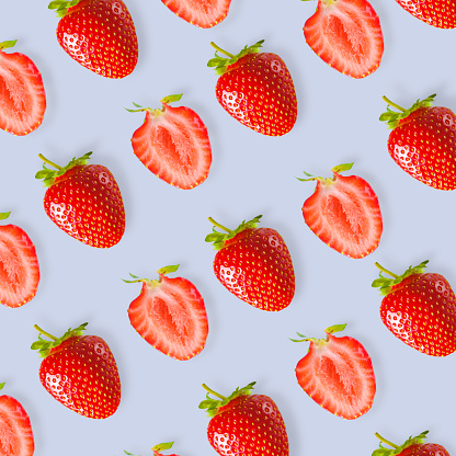 Beautiful pattern of fresh red strawberries on a colored background.