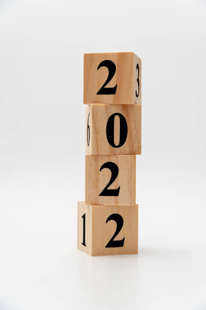 istock 2022 written on wooden blocks in vertical direction isolated on white background 1371302088