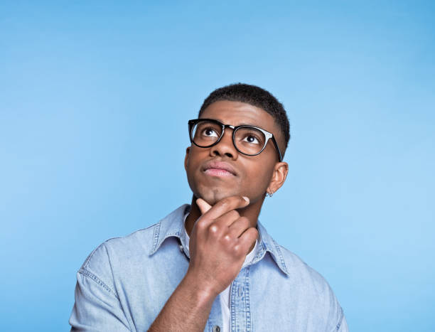 istock Thoughtful young man wearing denim shirt 1371302328