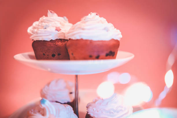 Close-up of homemade chocolate chip muffins with cream on top and decoration