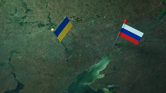 Russia and Ukrainian flags on the Russian and Ukraine border map. Horizontal composition with copy space.