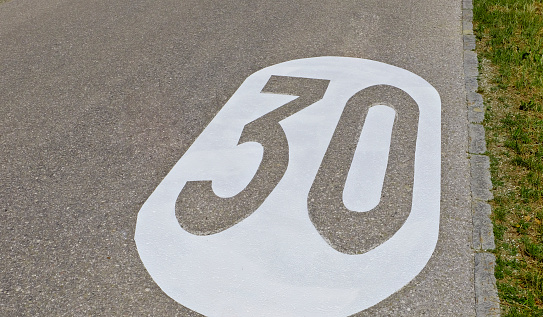 Maximum 40km/h road sign on the street, in the residencial area.
