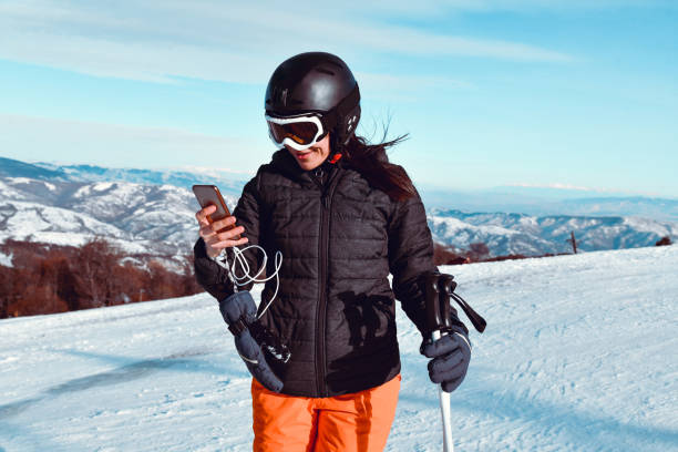 istock Female Skier Setting Up Music Playlist For Skiing 1371308018