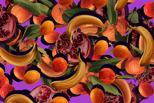 Mixed tropical fruit and exotic plant leaves on purple background