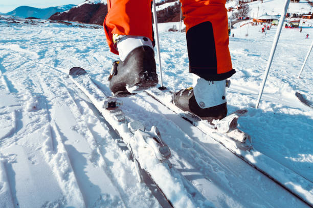 istock Skier Putting Ski Shoes On Ski Straps Before Going Downhill 1371308238