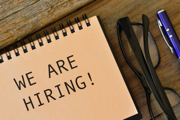 istock Eyeglasses and notebook written with WE ARE HIRING!. 1371309013