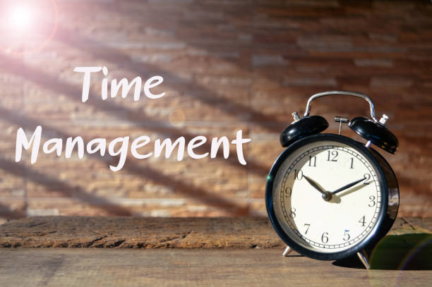 istock Front view of alarm clock on the table with text TIME MANAGEMENT. Selective focus 1371309102