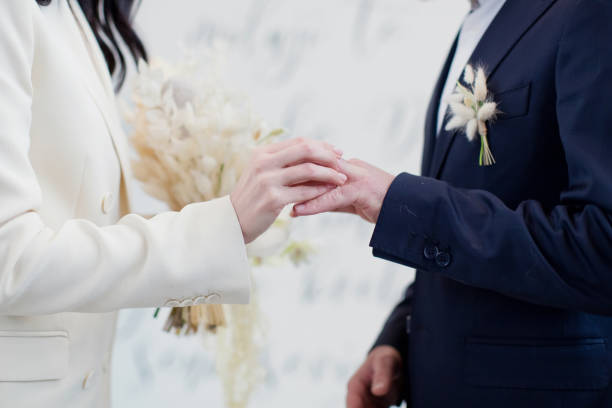 istock Bride and groom exchange wedding rings 1371309357