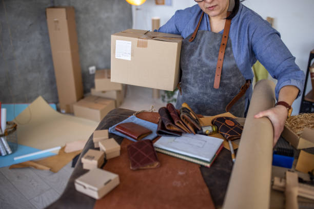istock Leather craftsman preparing to make wallet in her workshop 1371310338