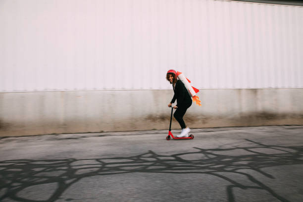 A businesswoman dressed in business attire wearing a homemade rocket pack gets ready to launch her new business.