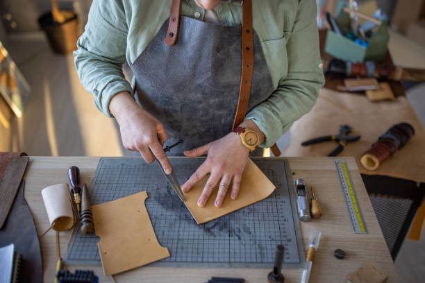 istock Leather craftsman working on new wallet in her workshop 1371311811