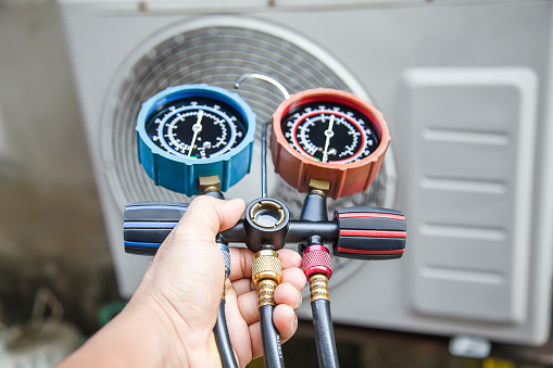 Air conditioner technician checks the operation of industrial air conditioners.