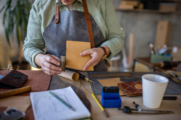 istock Female artisan working in her leather crafting workshop 1371313228