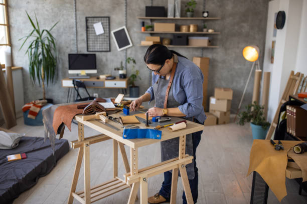 istock Female artisan working in her home leather crafting workshop 1371313233