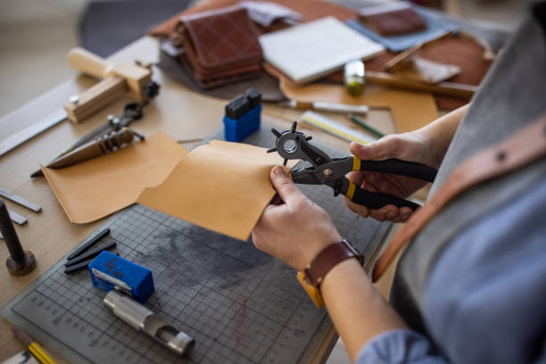 istock Leather craftsman working on new wallet in her workshop 1371313715