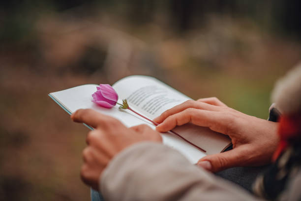 Young Woman Reading Book at Camp