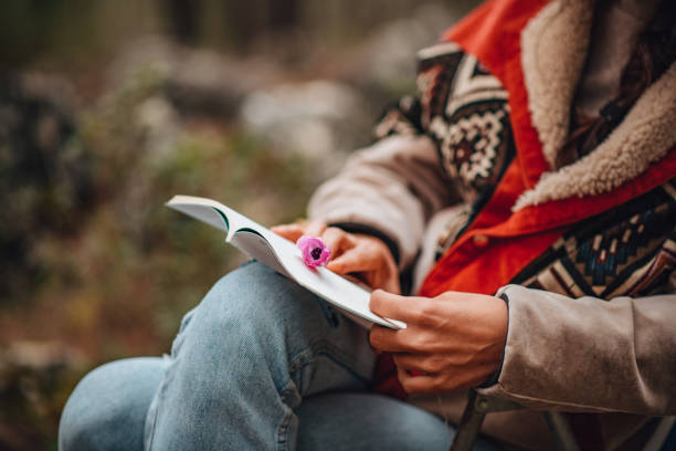istock Woman Reading Book at Forest 1371315719