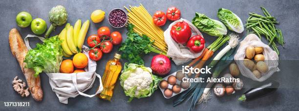 Groceries Shopping Flat Lay Of Fruits Vegetables Greens Bread And Oil In Eco Friendly Bags Top View Stock Photo - Download Image Now