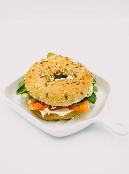 istock Bagel stuffed with smoked salmon, fresh cheese and arugula 1371318323