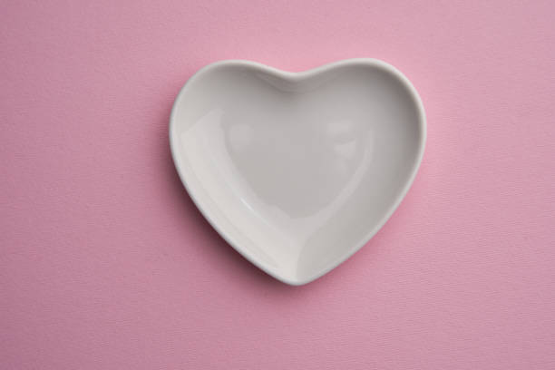 istock white ceramic heart shape plate on pink background 1371318986