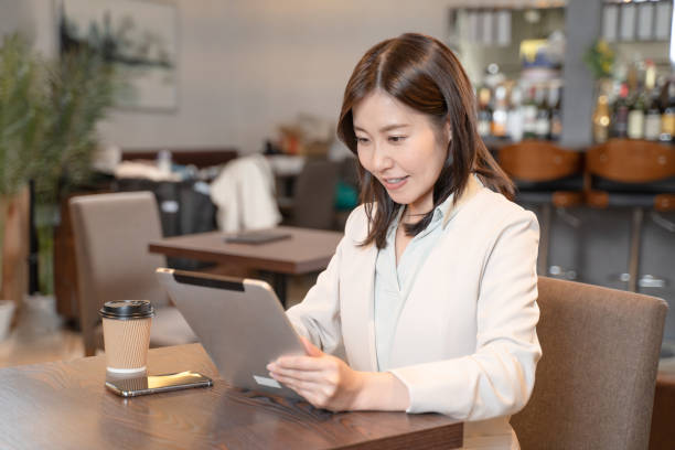 istock A woman operating a tablet in a cafe 1371319612