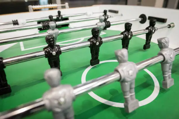 Close up photo of table football players, black and grey.