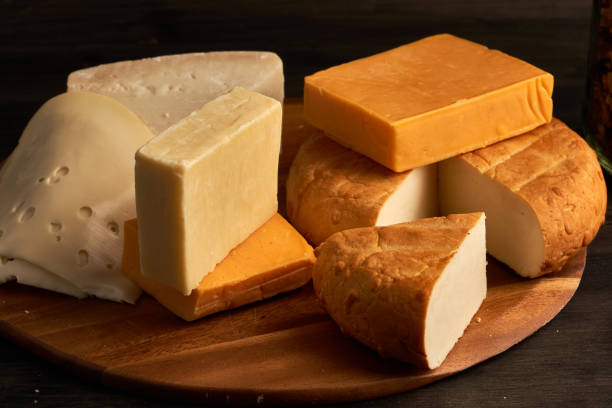 Variety of cheese on a wooden board stock photo