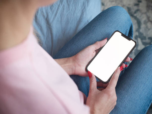 istock Woman using smartphone with blank screen at home 1371321655