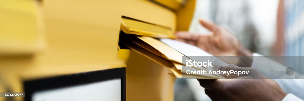 Letter In Envelope Or Document In Mailbox Letter In Envelope Or Document In Mailbox. Man Hand Sending Mail Envelope Stock Photo