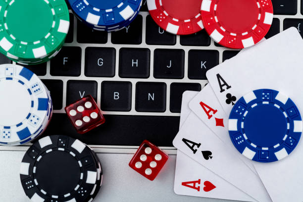 istock Gambling chips and playing card on laptop keyboard 1371324540