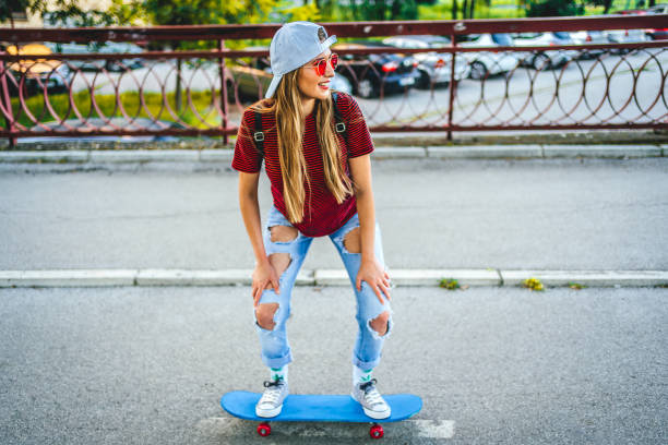istock Young woman riding skateboard 1371324822
