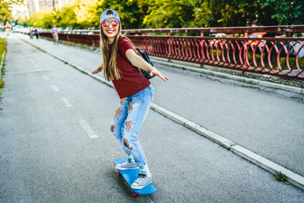 istock Young woman riding skateboard 1371324863