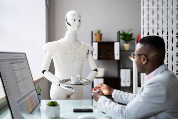 istock Humanoid Cyborg AI Robot Assistant Bringing Coffee To Boss 1371325589