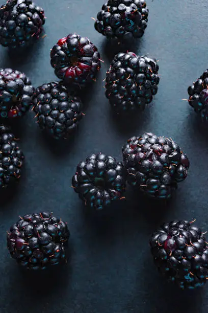 Fresh blackberries, close-ups on a dark background. Top view, flat lay