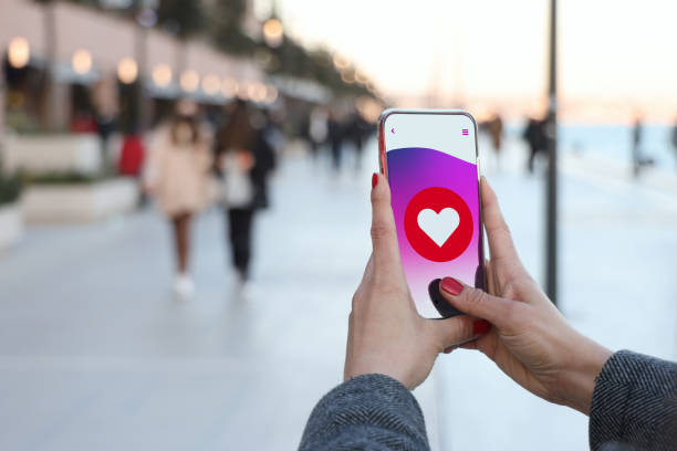 istock Hand holding smart phone with sending heart shape 1371326024