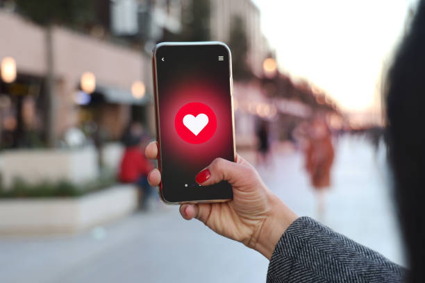 istock Hand holding smart phone with sending heart shape 1371326063