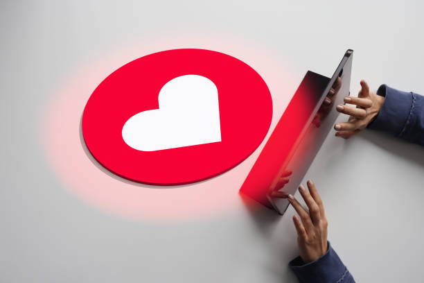 Woman using digital tablet with sending heart shape