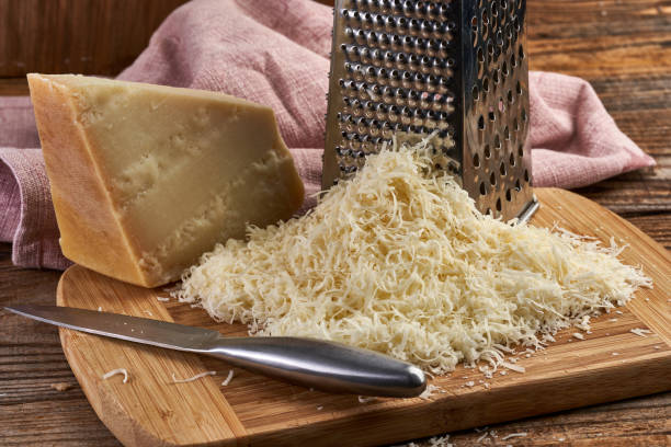 Parmesan grated in closeup Portion of parmesan grated from a large block of parmigiano reggiano grana padano stock pictures, royalty-free photos & images