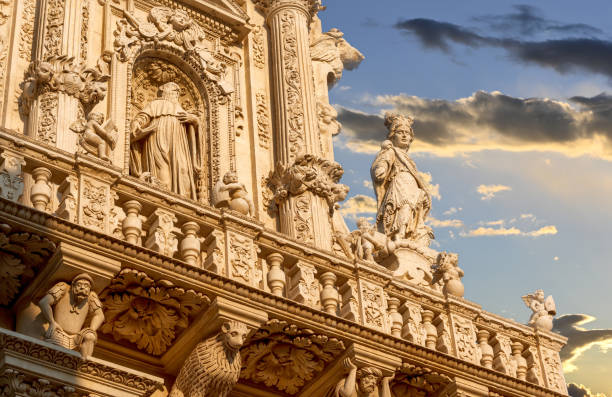 Lecce, Puglia, Italy. August 2021. Lecce, Puglia, Italy. August 2021. The church of Santa Croce is the finest example of Lecce baroque. Detail of the facade illuminated by the warm light of the evening. lecce stock pictures, royalty-free photos & images